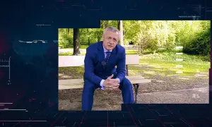 Mężczyzna w garniturze siedzi na ławce w parku. W tle widać cyfrowe dane i napis RODO.