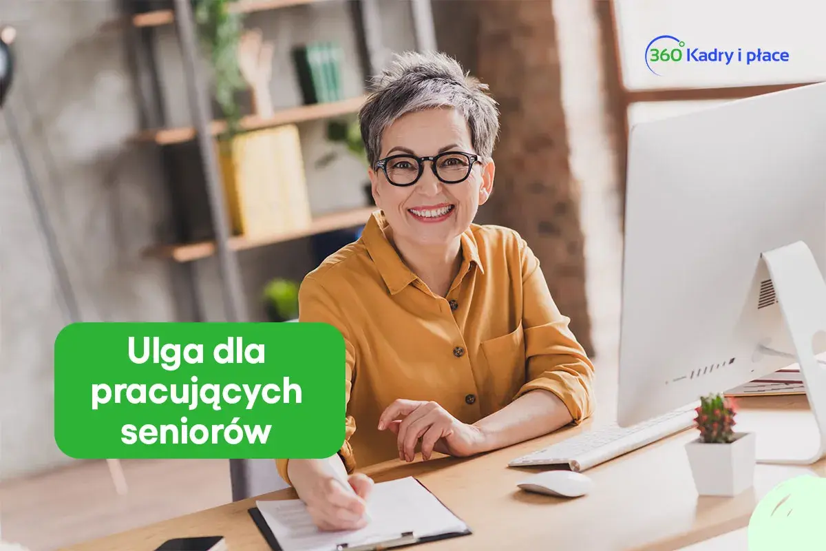 Uśmiechnięta kobieta w okularach przy biurku. Zielony napis "Ulga dla pracujących seniorów" informuje o korzyściach.