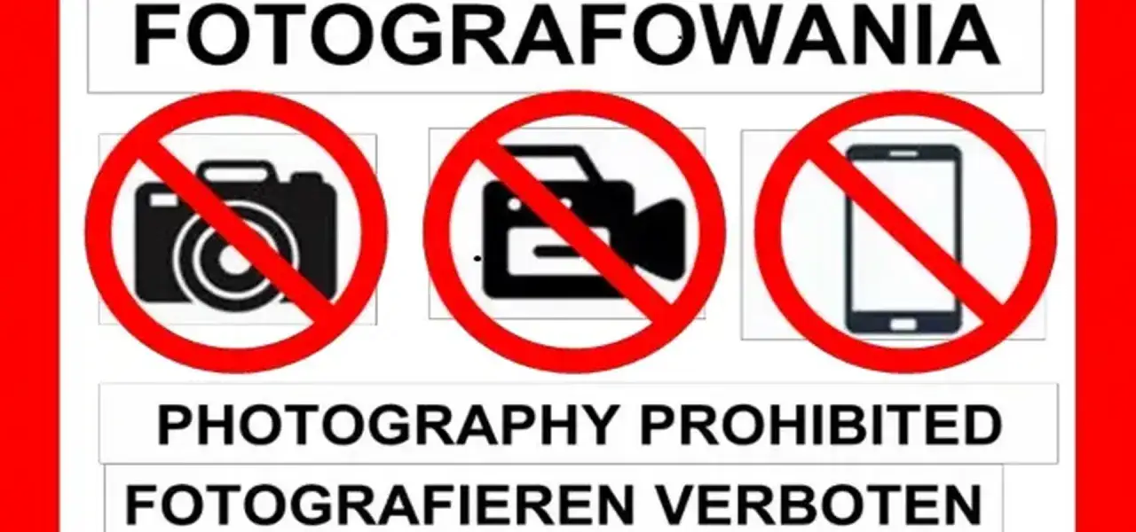 Zakaz fotografowania. Na znaku widać przekreślony aparat, kamerę i telefon.